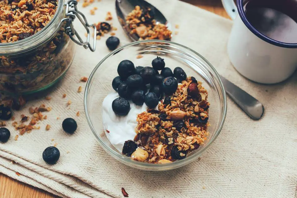whole foods breakfast with oatmeal, yogurt and blueberries