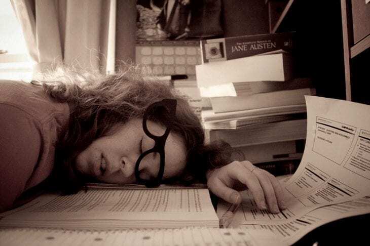 picture of woman sleeping at her desk to show how to avoid things that make you sleepy before bed